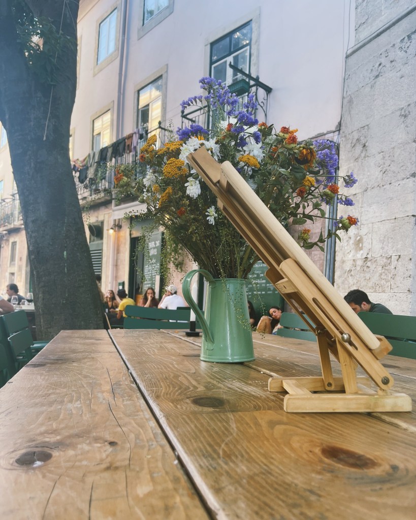 Sitting outside on the sidewalk of Insaciável, a wine bar in Lisbon, Portugal